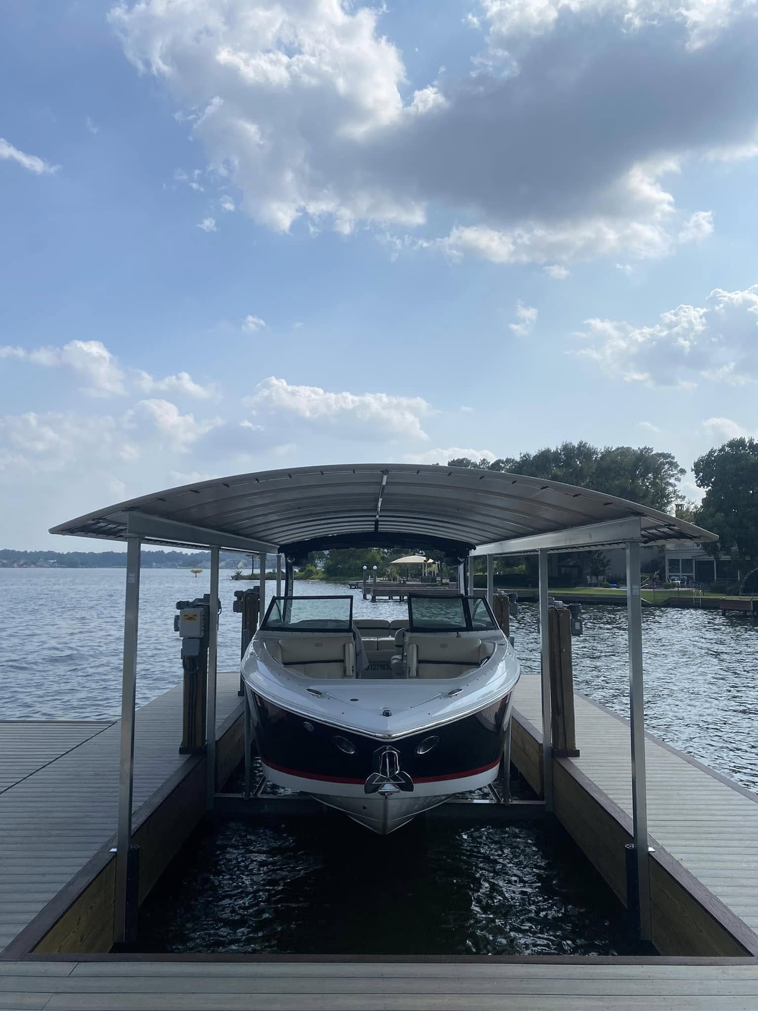 Custom covered boat dock with aluminum canopy and cable lift